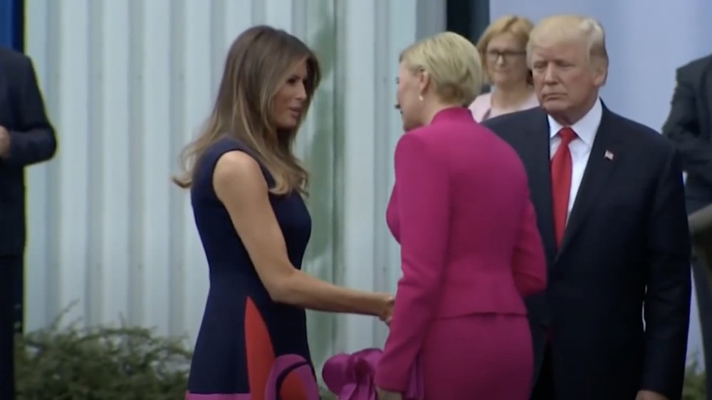 Melania Trump and Donald Trump greeting the first lady of Poland