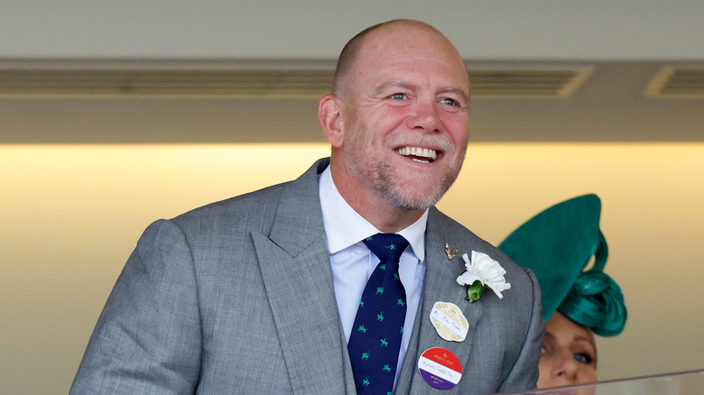 Mike Tindall smiling in gray blazer and blue tie