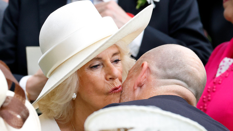 Mike Tindall kissing Queen Camilla on the cheek