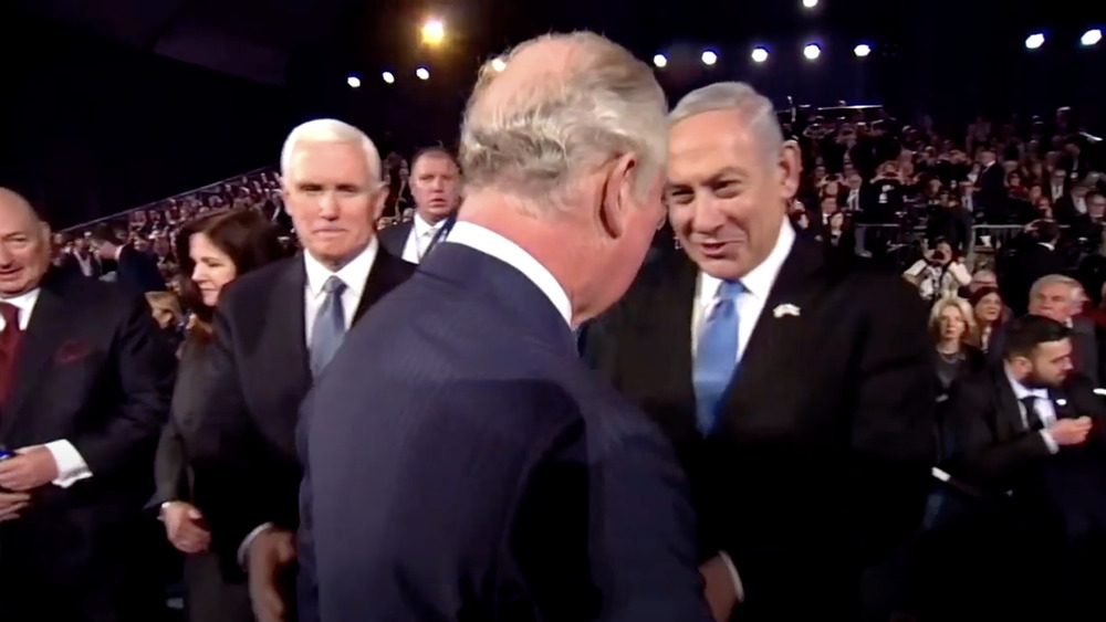 Prince Charles and Mike Pence acknowledging each other