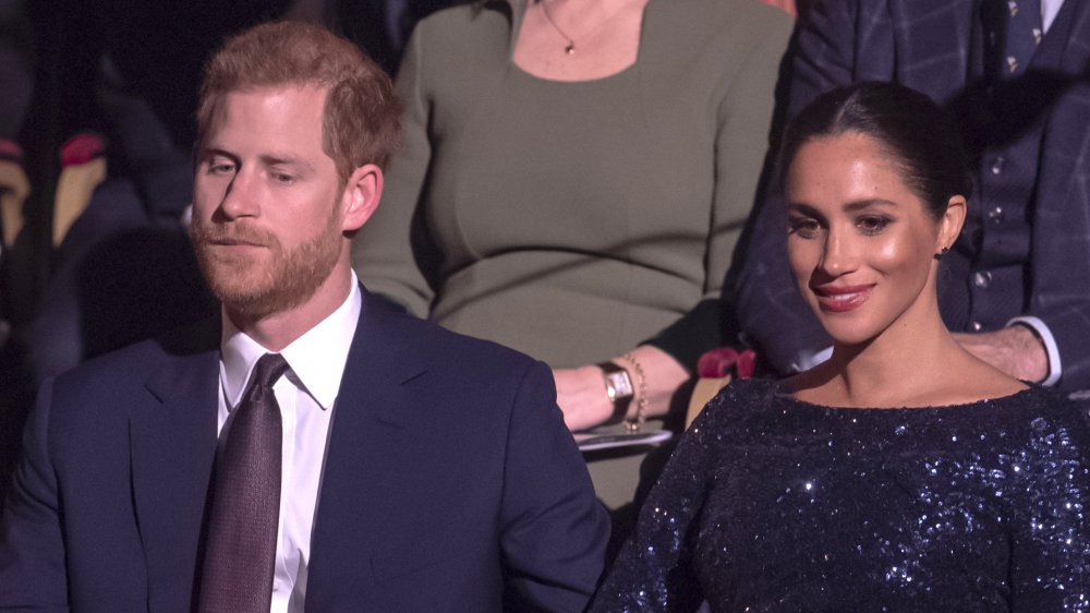 Prince Harry and Meghan Markle seated at an event