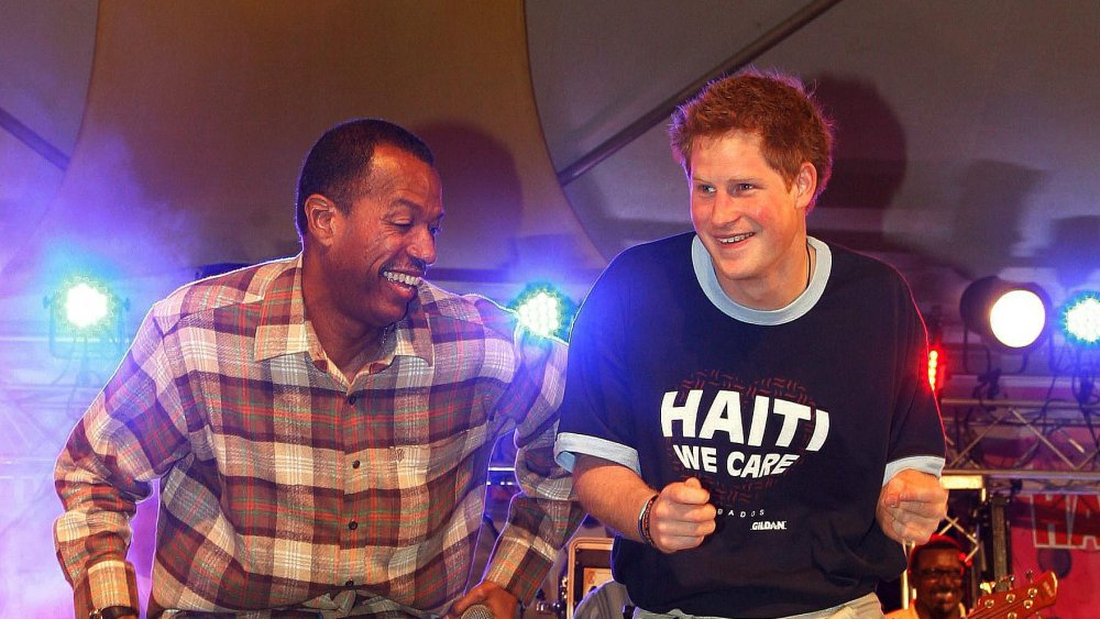 Prince Harry dancing with a man in a plaid shirt