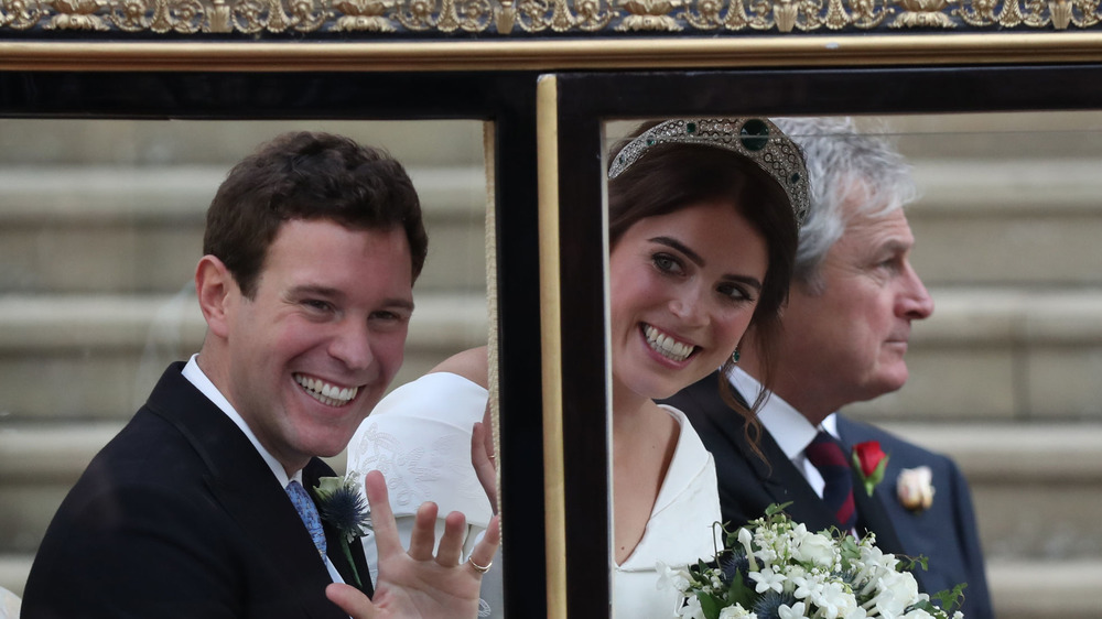 Princess Eugenie and her husband waving at their wedding 