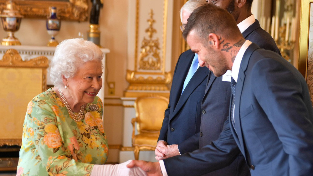 Queen Elizabeth and David Beckham shaking hands