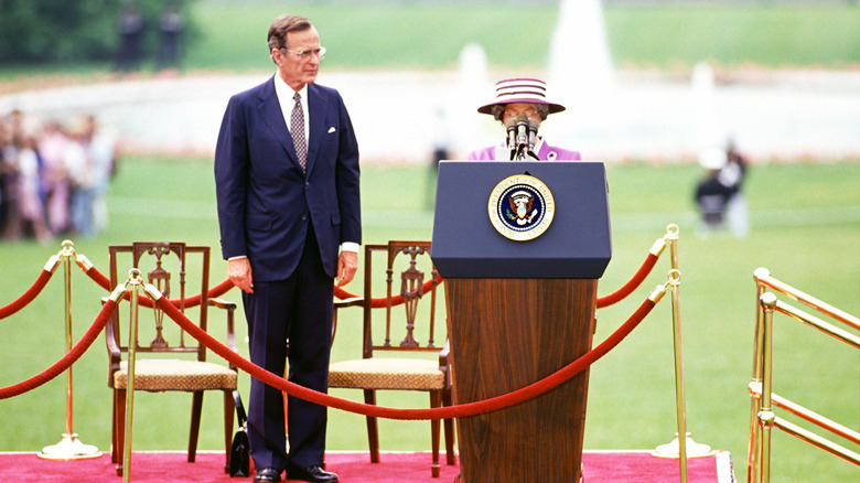 Queen behind the podium 