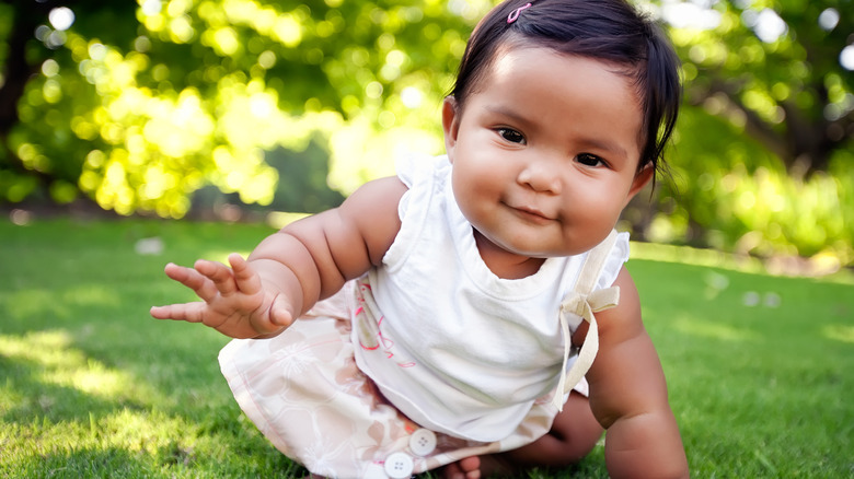 happy curious baby crawling 