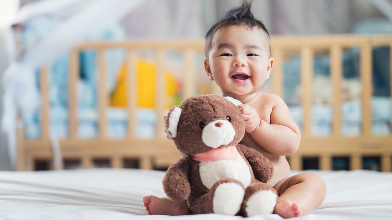 smiling baby with toy 