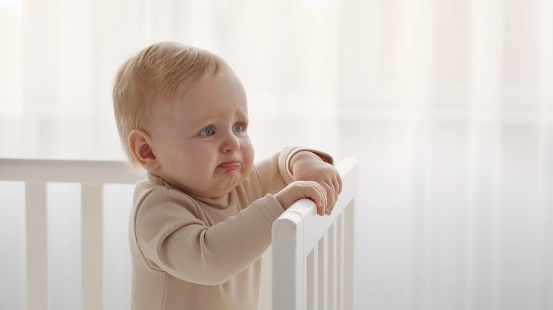 baby pouting in crib 