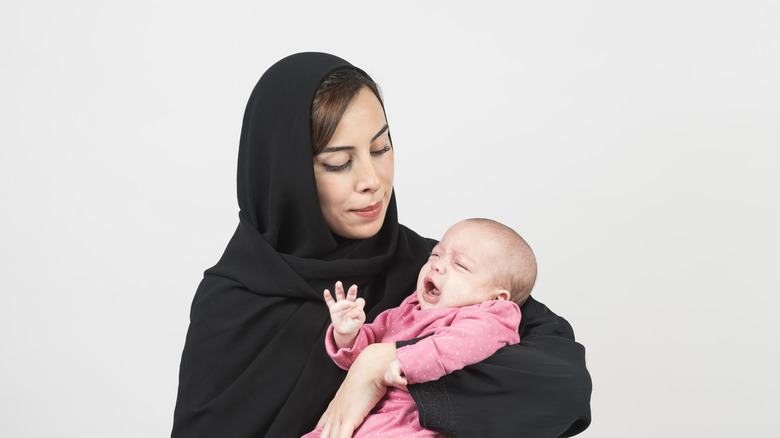 Modestly dressed woman with baby