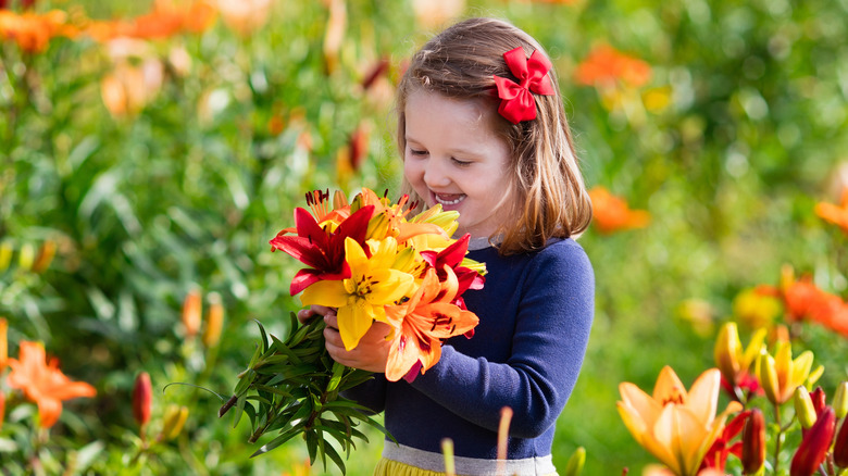 Child smelling lilies