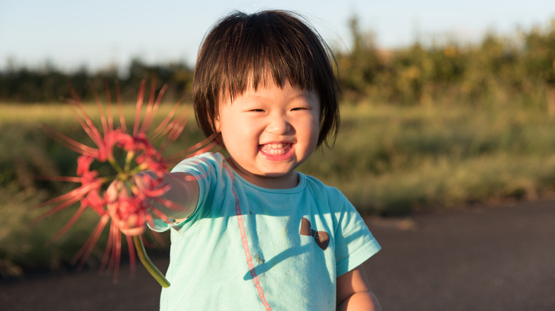 Baby girl holding flower