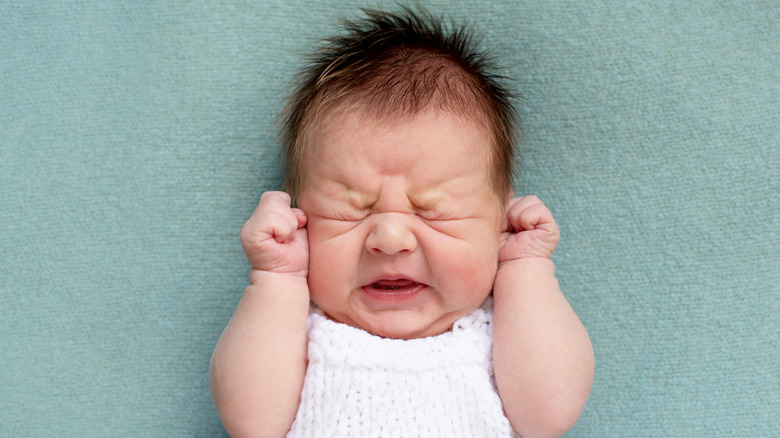 Newborn baby with eyes closed