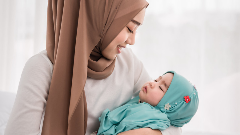 Mother holding sleeping baby