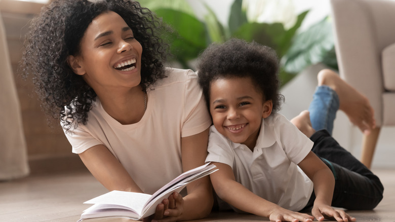 Mom and son reading, laughing