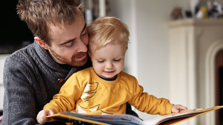 Man reading baby boy a book