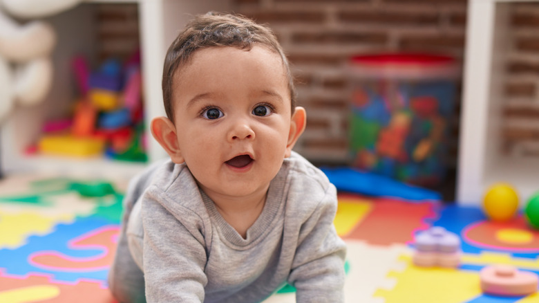 Baby crawling on a mat