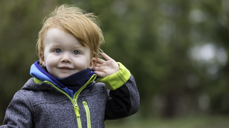 Baby boy posing outside