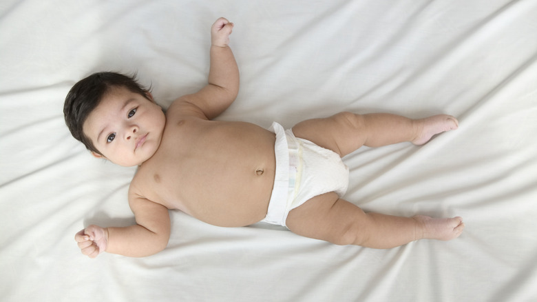 Baby boy lying on a bed