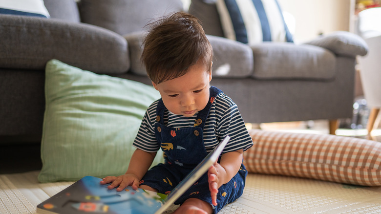 Baby boy reading a book