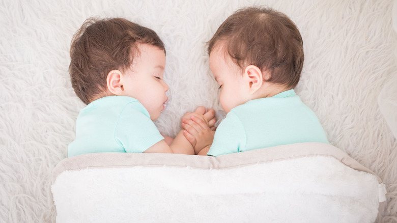 twin boys holding hands