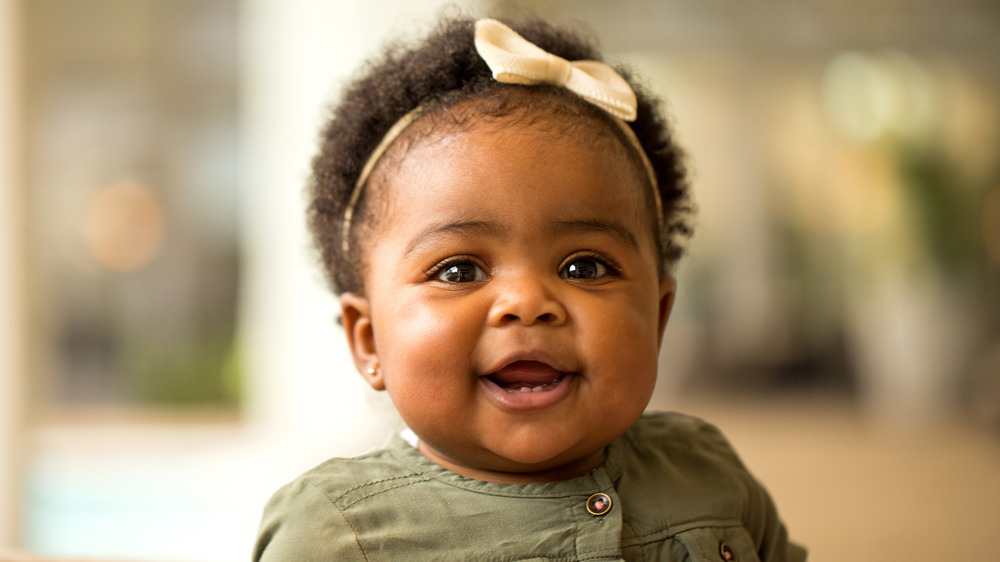 Baby girl with yellow bow in hair