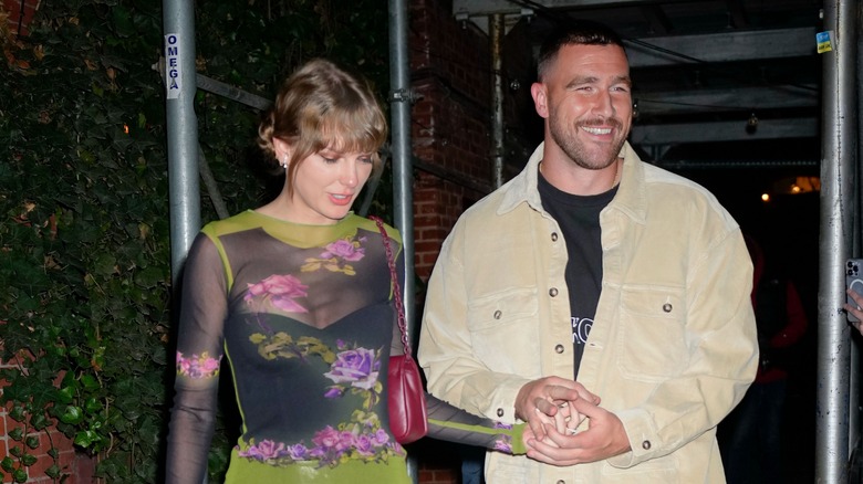 Taylor Swift and Travis Kelce holding hands