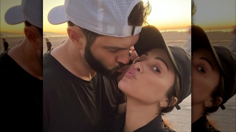 Andi Dorfman and fiance Blaine Hart posing on the beach