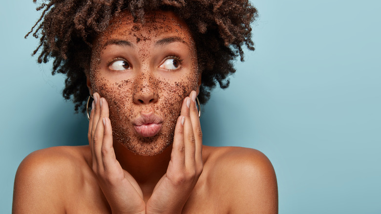 woman exfoliating her face