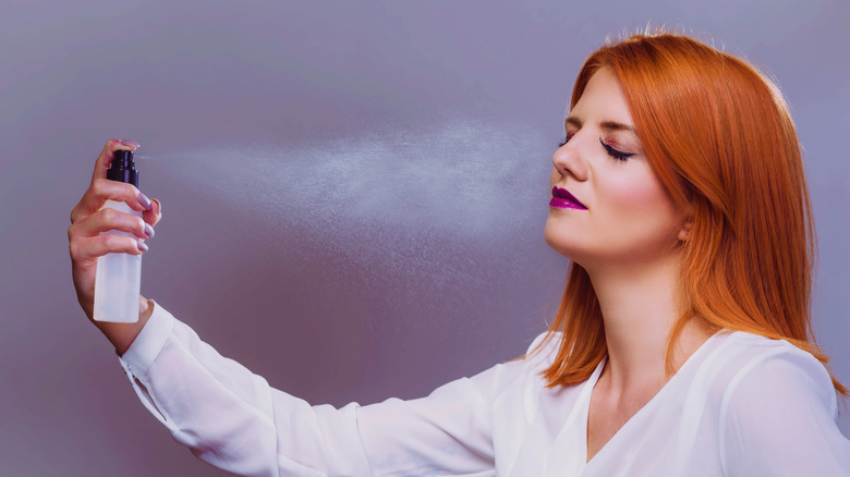 woman using setting spray