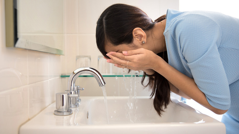 woman washing her face