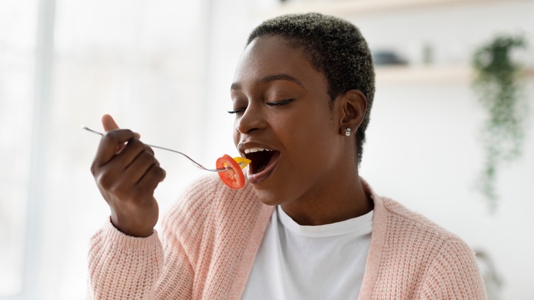 A woman eating vegetables 