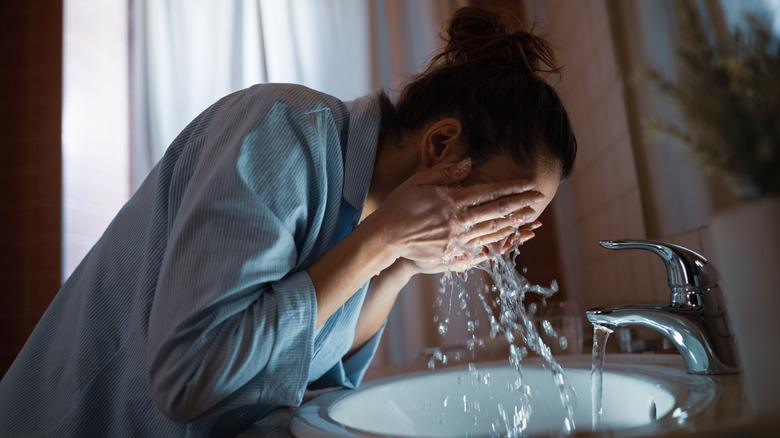 A woman washing her face 