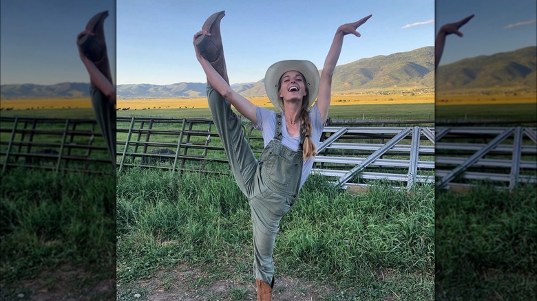 Hannah Neeleman dancing in field in overalls and hat