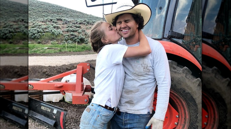 Hannah Neeleman in white tee and jeans kissing husband