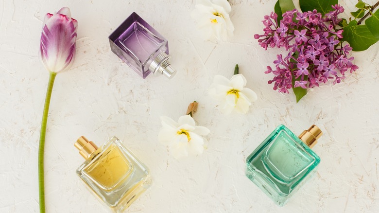 Perfume and flowers on table