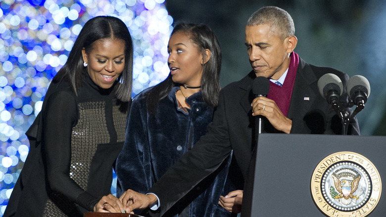 Barack and Michelle Obama with their daughter