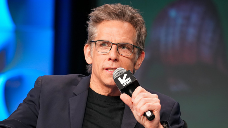 Ben Stiller holds a microphone