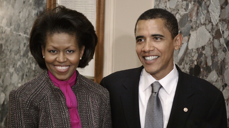 Michelle and Barack Obama smiling at senator swear in