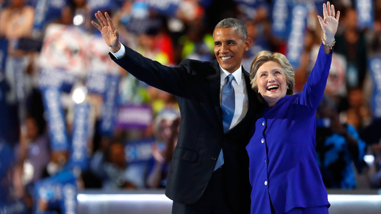 Barack Obama and Hillary Clinton waving