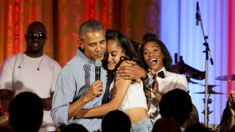 Barack Obama hugging Malia Obama 