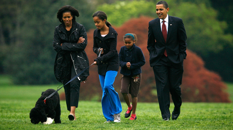 The Obama family walking with their dog