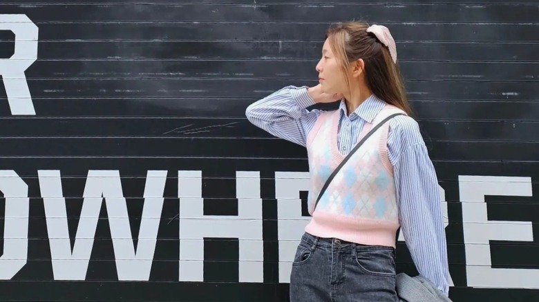 A woman posing in a vest