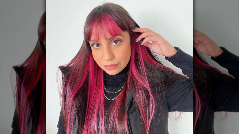 Woman with dark brown and pink hair