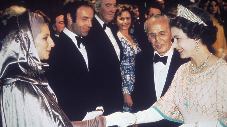 Barbara Streisand and Queen Elizabeth shaking hands