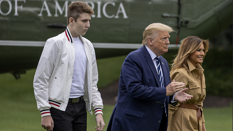 Barron Trump walks behind Donald and Melania Trump