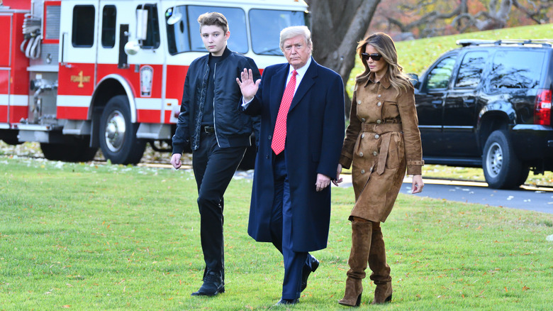 Barron Trump walking with Donald Trump and Melania Trump