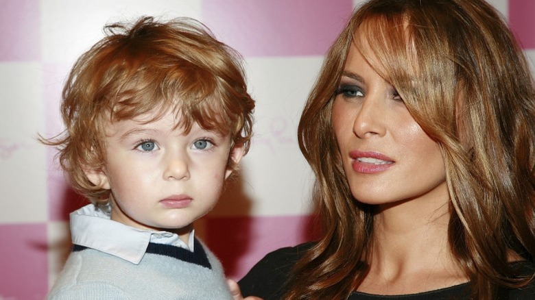 Toddler Barron Trump held by mother Melania Trump