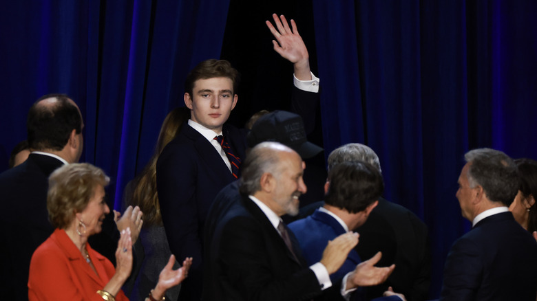 Barron Trump waving in a crowd