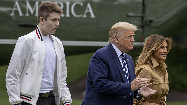 Barron walking with his parents