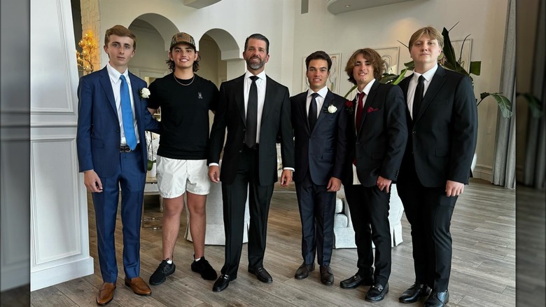 Prom goers standing with Donald Trump III, Donald Trump Jr., and Ronan Villency 